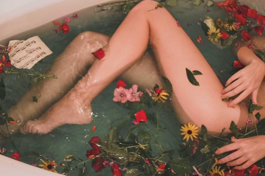 ragazza in una vasca da bagno con dei fiori