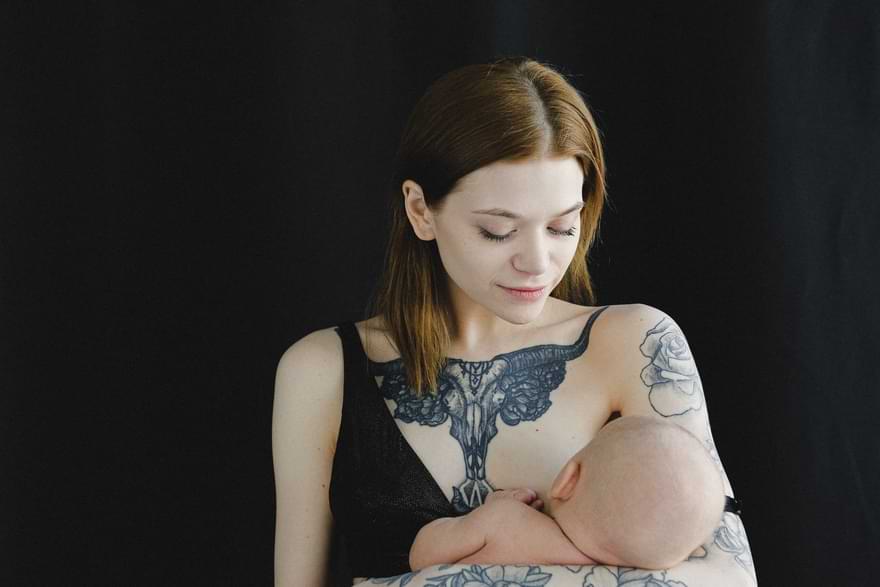 ragazza che allatta il suo bambino al seno